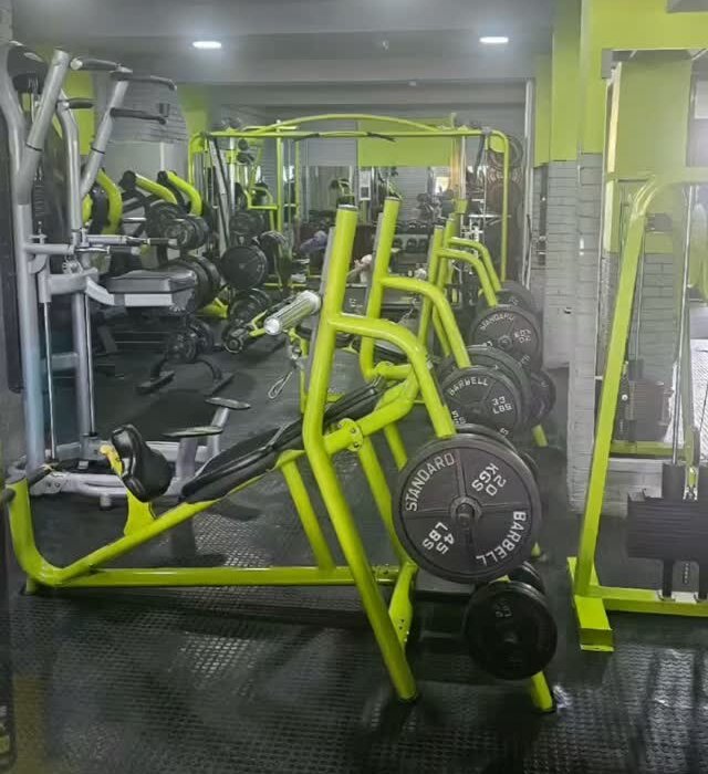 Rows of lime-green plate-loaded strength machines on the Supreme gym floor