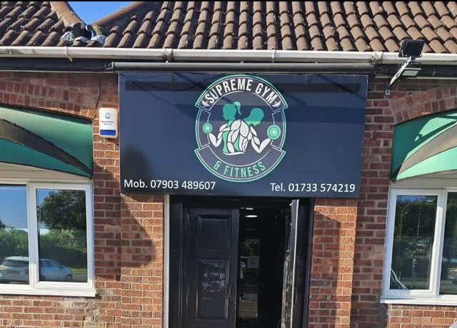 Supreme Gym & Fitness shopfront with its round badge sign above the door